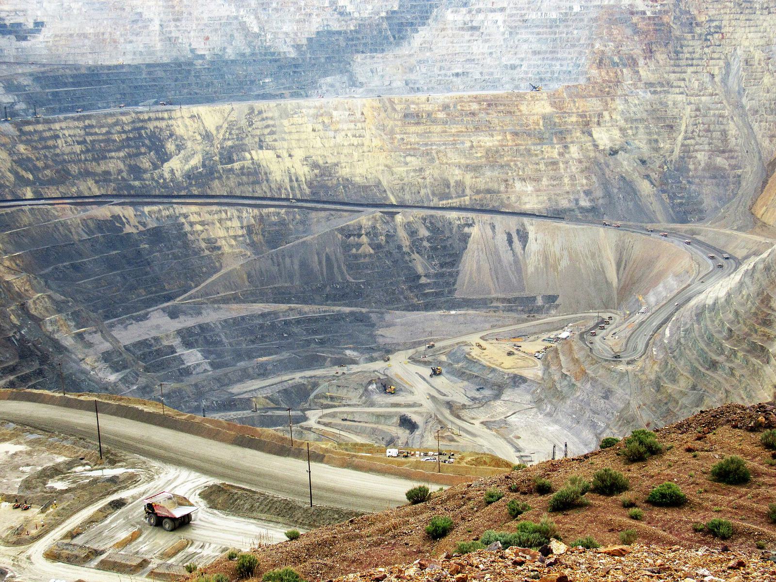 The terraced walls of the Bingham Canyon copper pit under a hazy sky